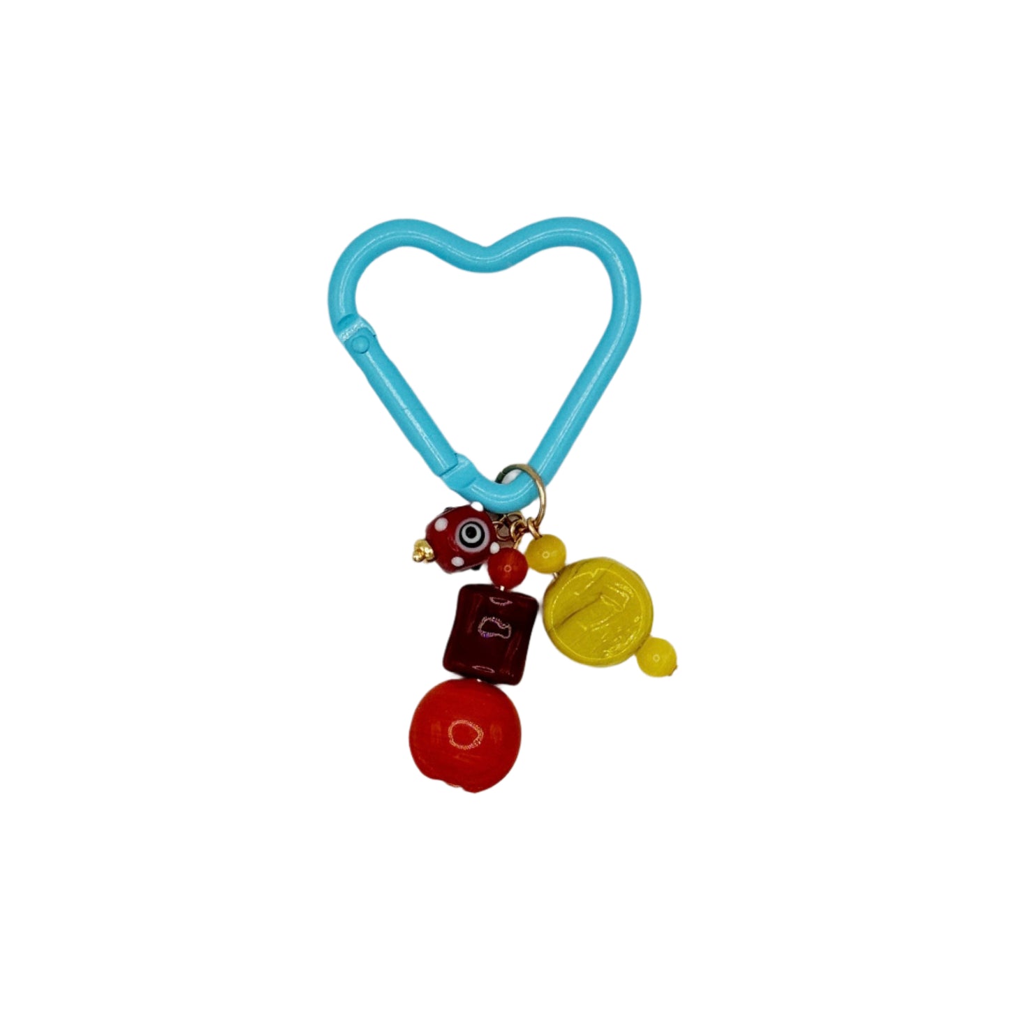 Heart-shaped blue keychain with colorful charms on a white background