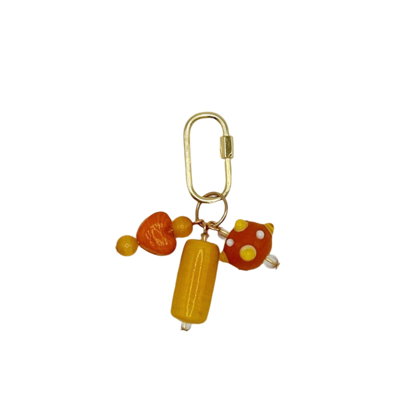 Gold keychain with orange and yellow beads on a light gray background