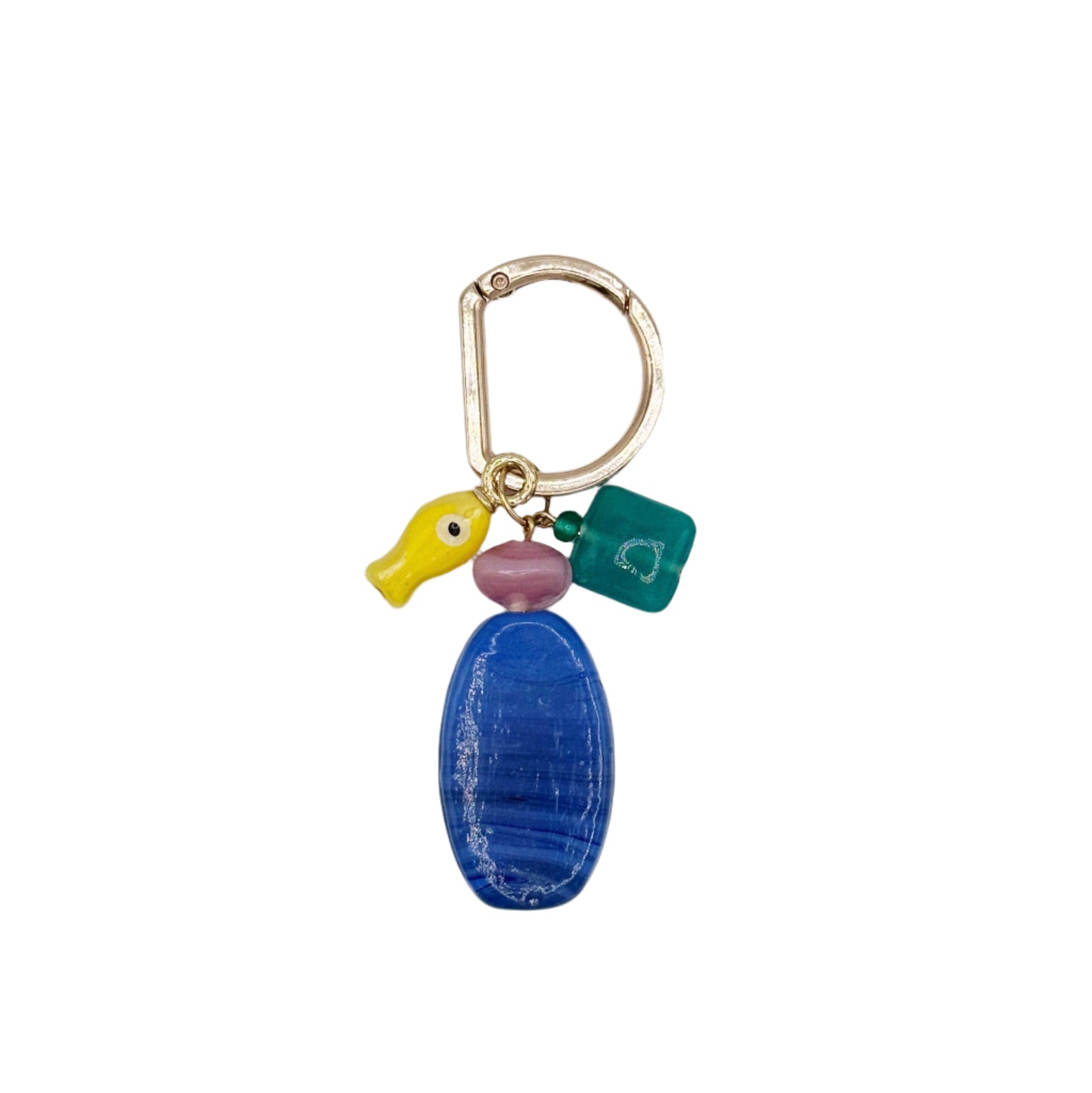 Keychain with blue oval charm, yellow duck, and green tag on a light gray background
