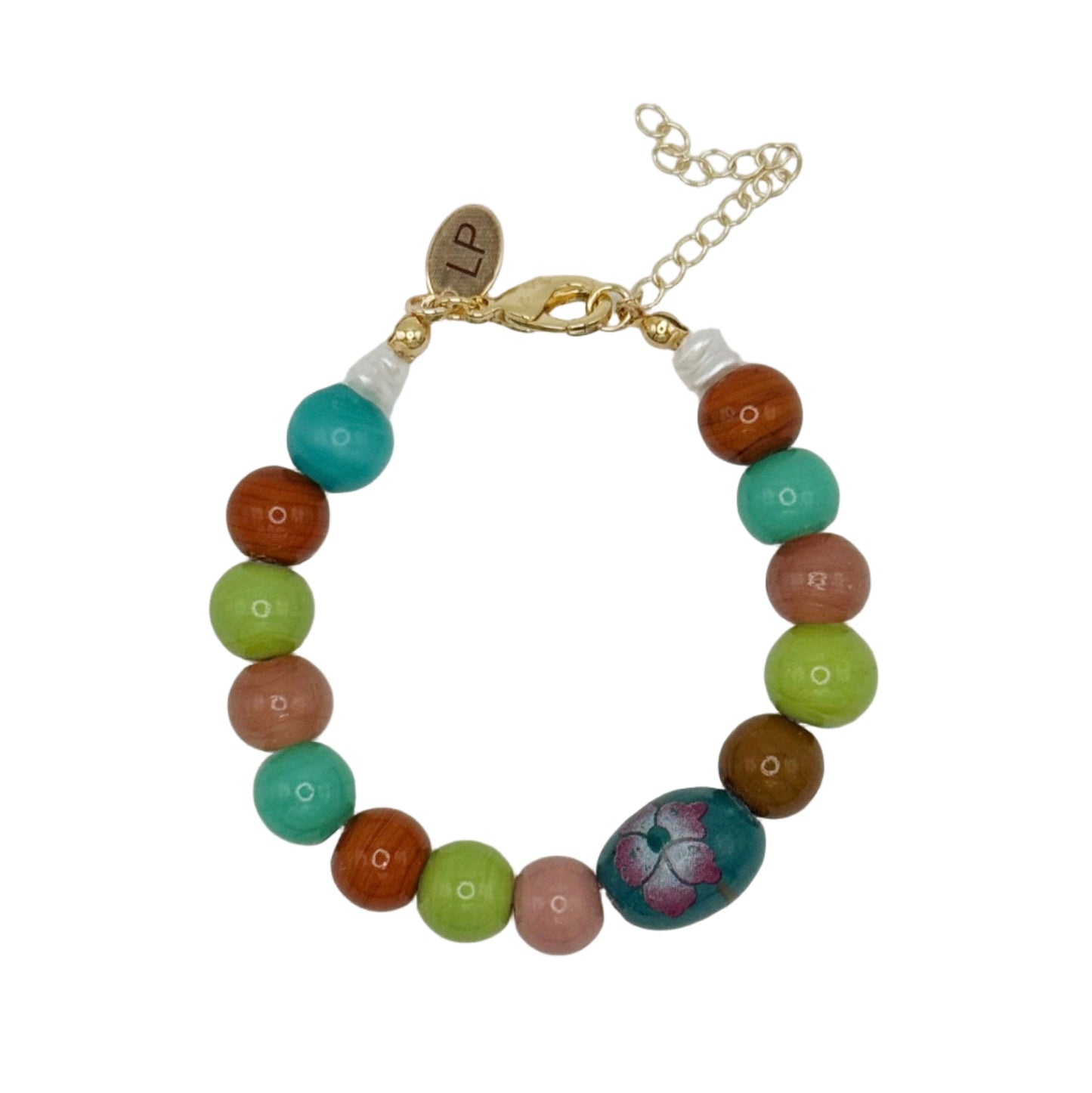 Multicolored beaded bracelet with a floral charm on a white background