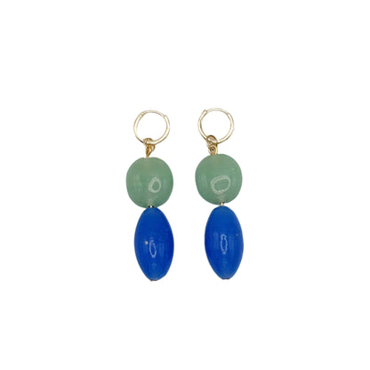 Pair of earrings with green and blue beads on a white background