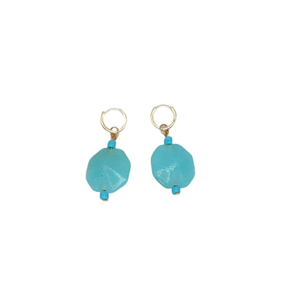 Pair of turquoise earrings on a light gray background