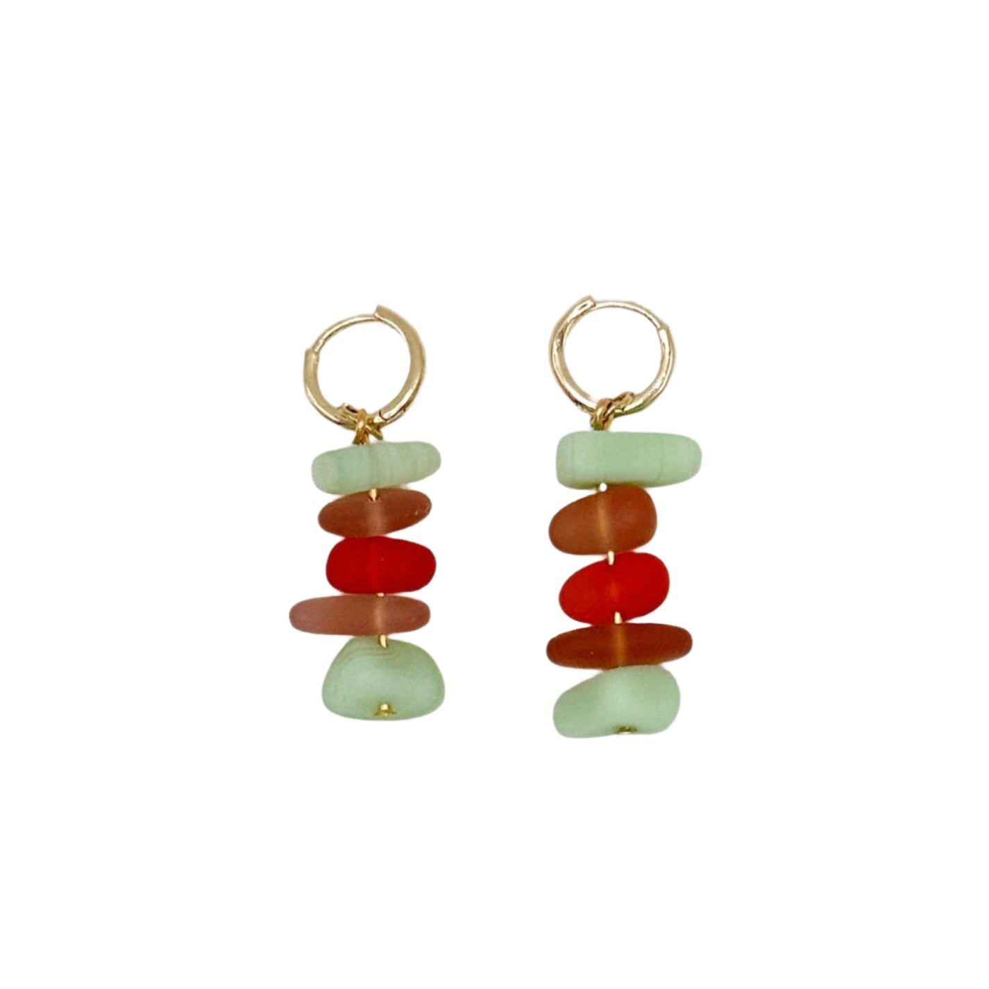 Pair of earrings with stacked green and red stones on a white background