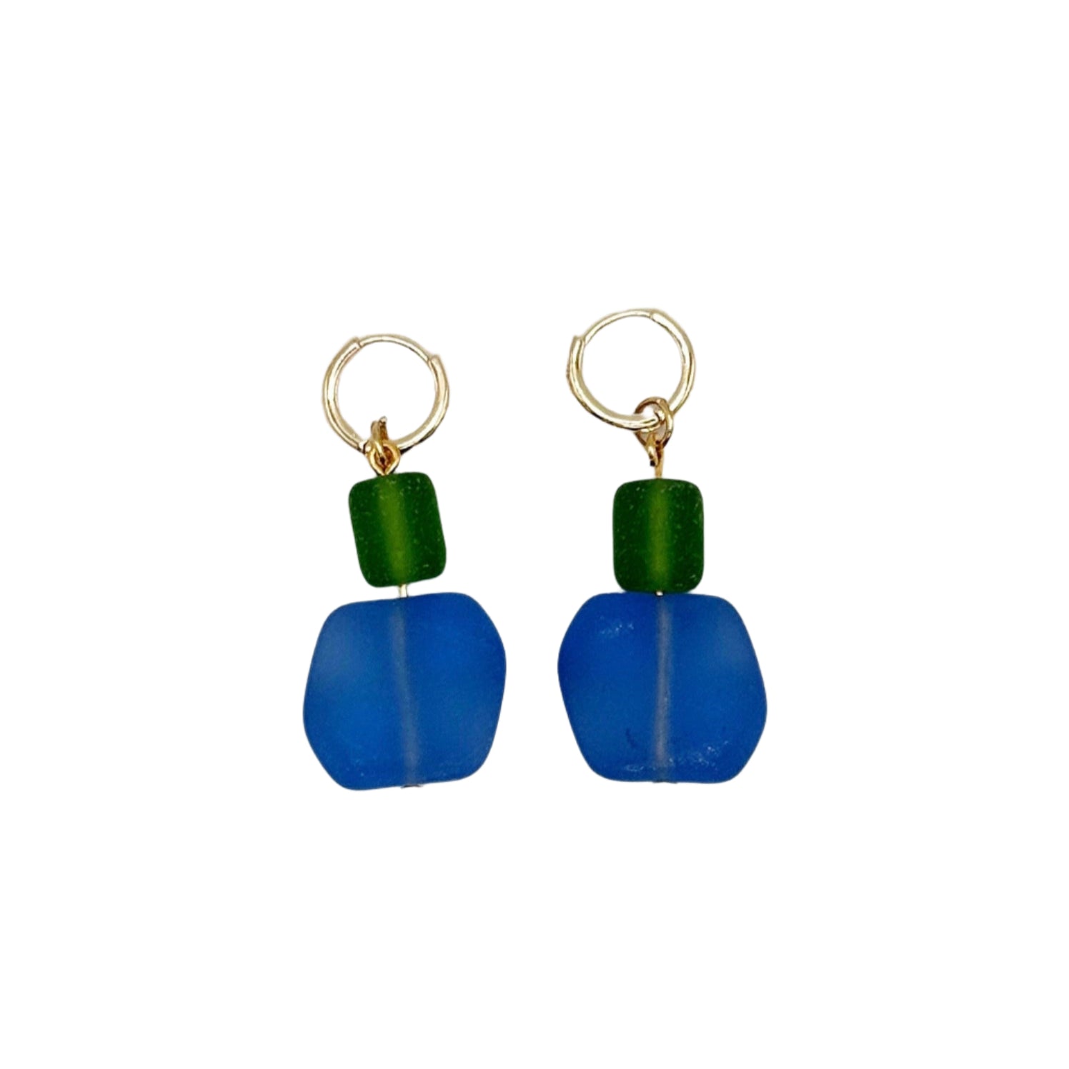 Pair of blue earrings with green beads on a white background