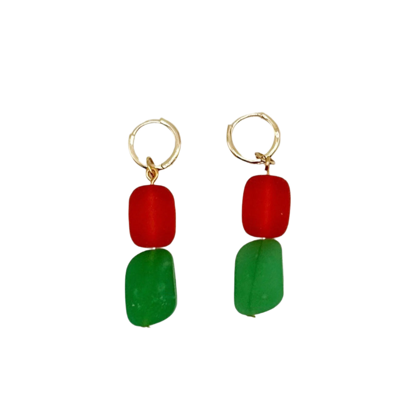 Pair of earrings with red and green beads on a white background