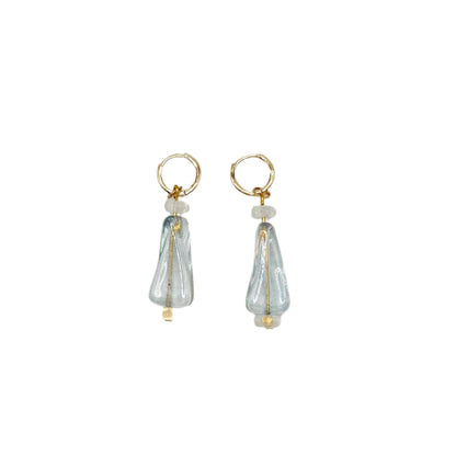 Pair of earrings with clear teardrop-shaped charms on a white background
