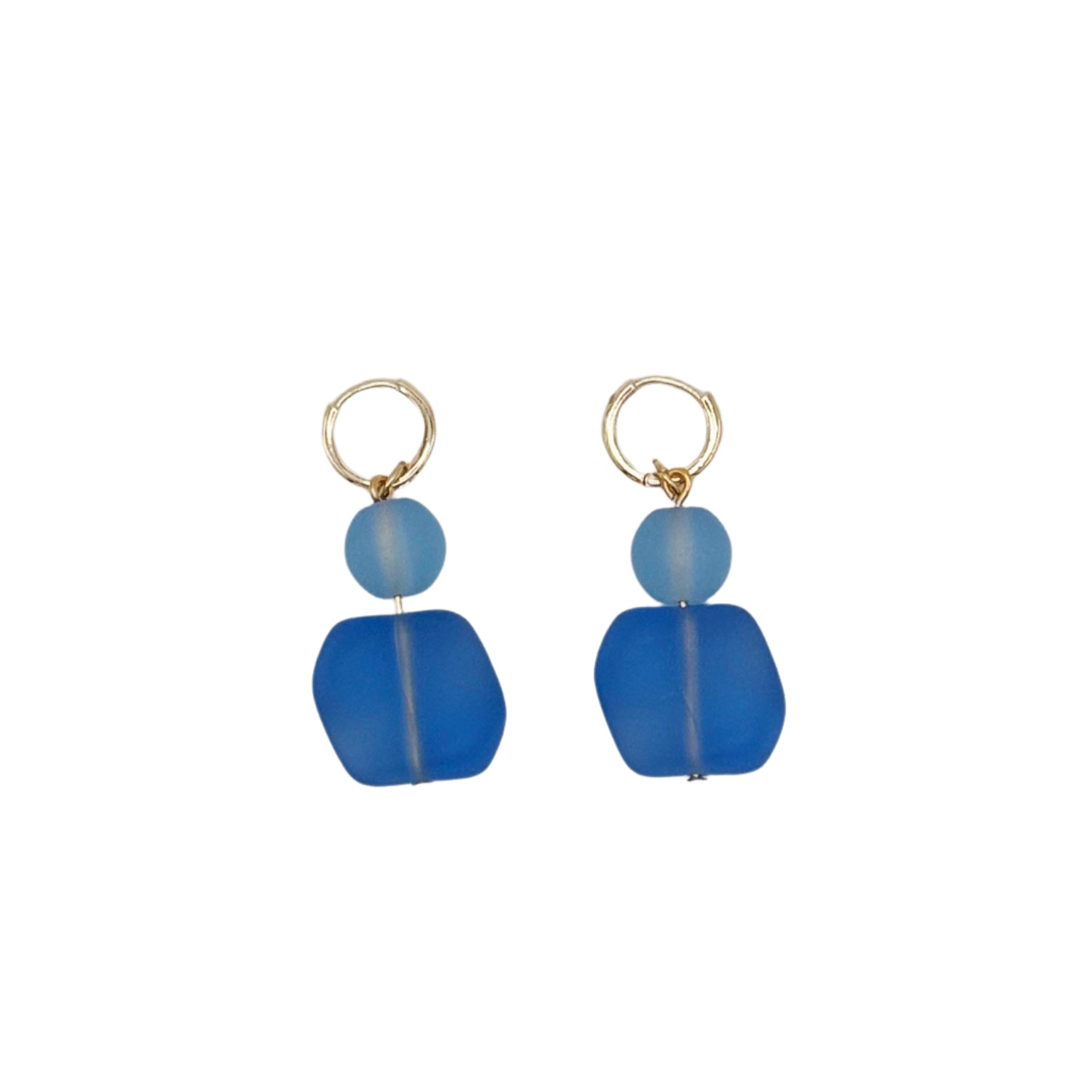 Pair of blue beaded earrings on a light gray background