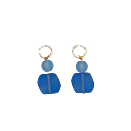 Pair of blue beaded earrings on a light gray background