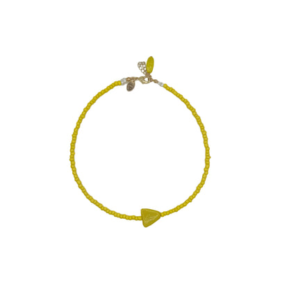Yellow beaded necklace with a triangle charm on a white background