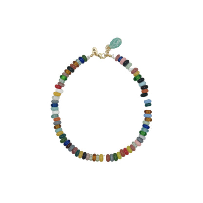 Multicolored beaded necklace with a green leaf pendant on a white background