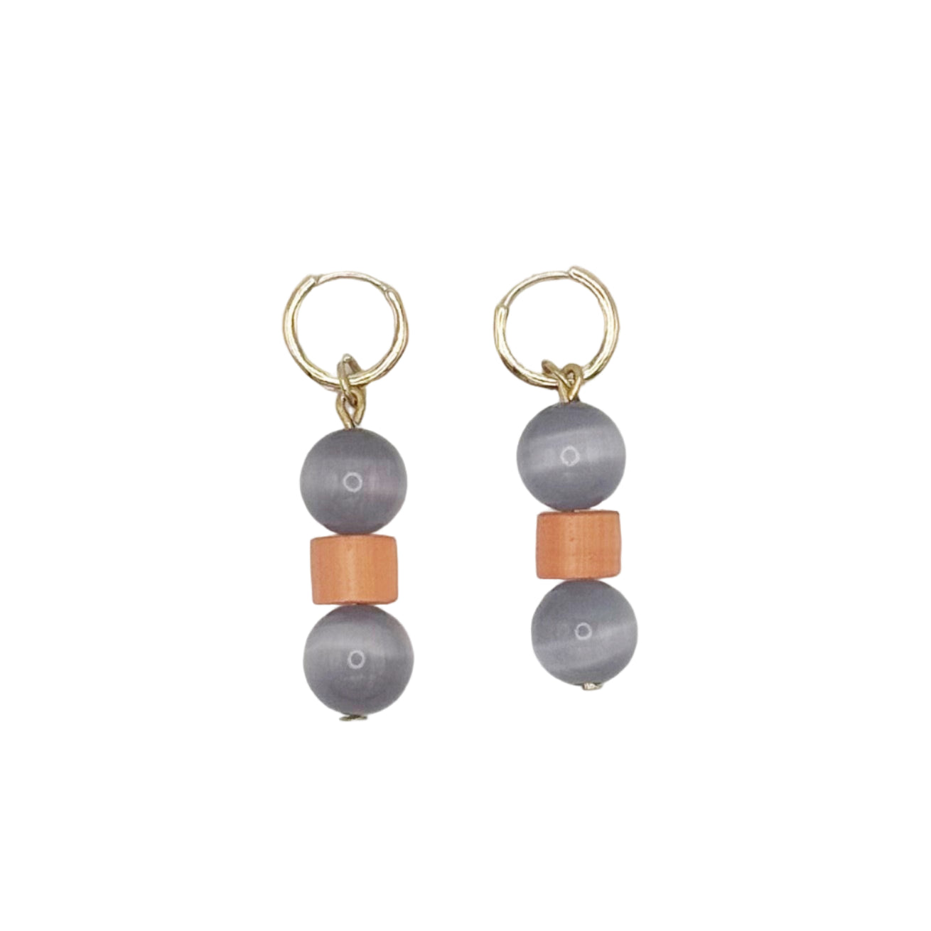 Pair of earrings with gray beads and orange accents on a light gray background