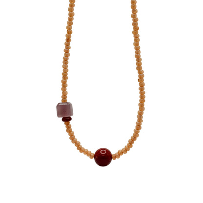 Necklace with beads on a light gray background