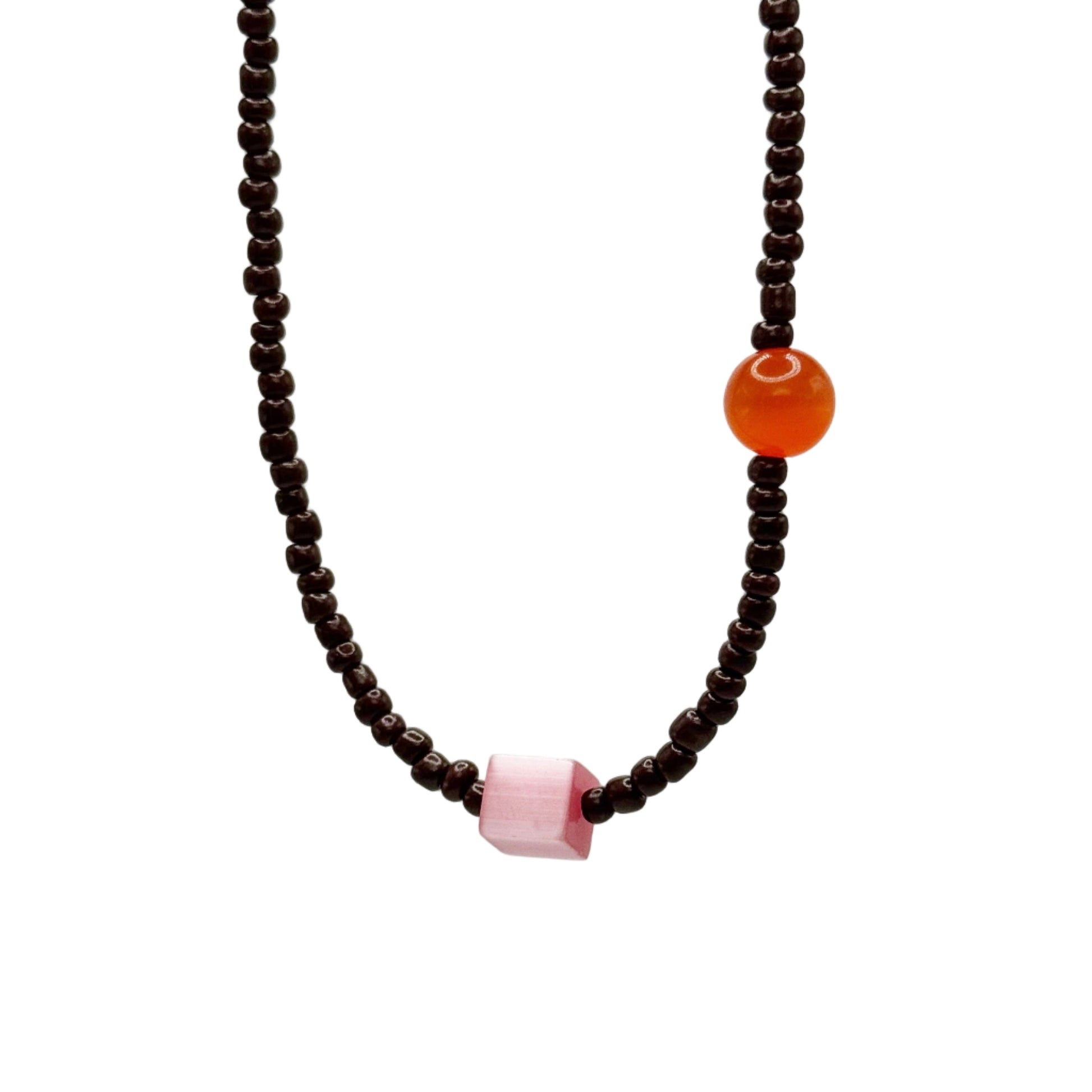 Necklace with brown beads and colored stones on a light gray background