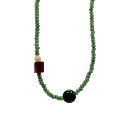 Necklace with green beads on a white background