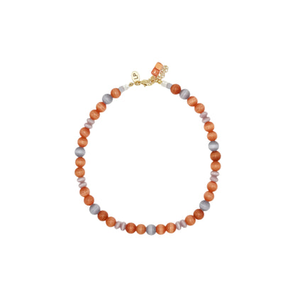Necklace with orange and gray beads on a white background