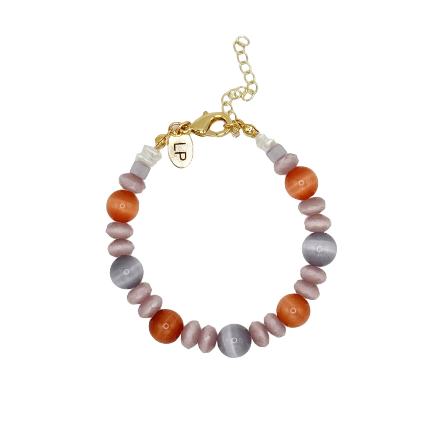 Beaded bracelet with multicolored beads and a gold charm on a light gray background