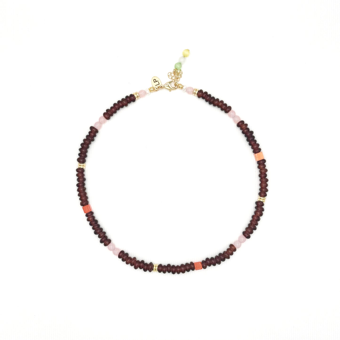 Beaded necklace with red and pink beads on a white background