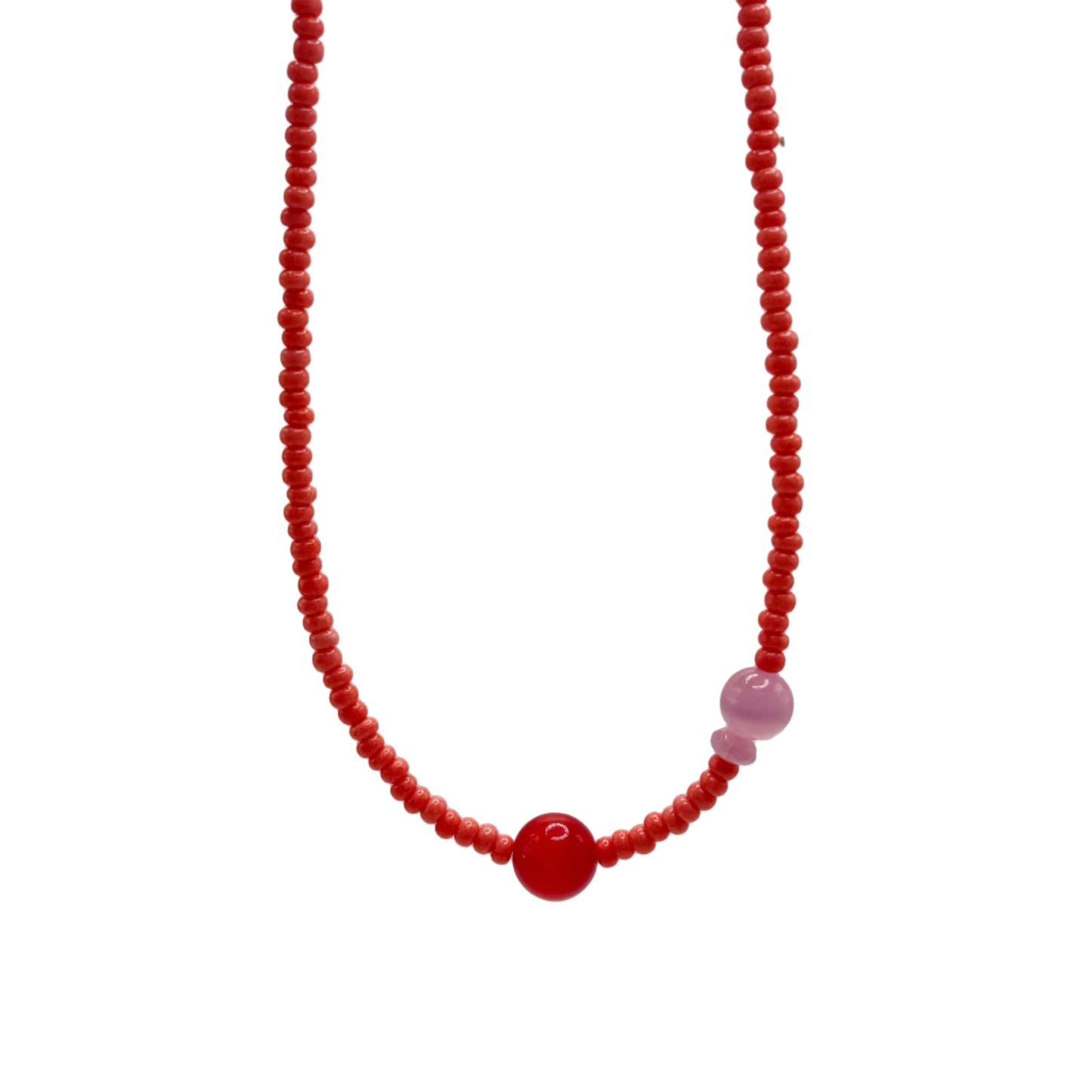 Necklace with red beads on a light gray background
