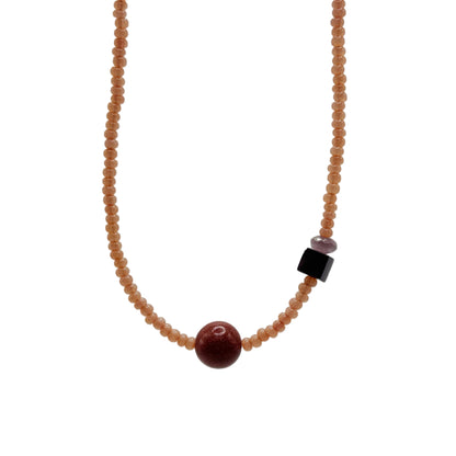 Necklace with beads on a light gray background