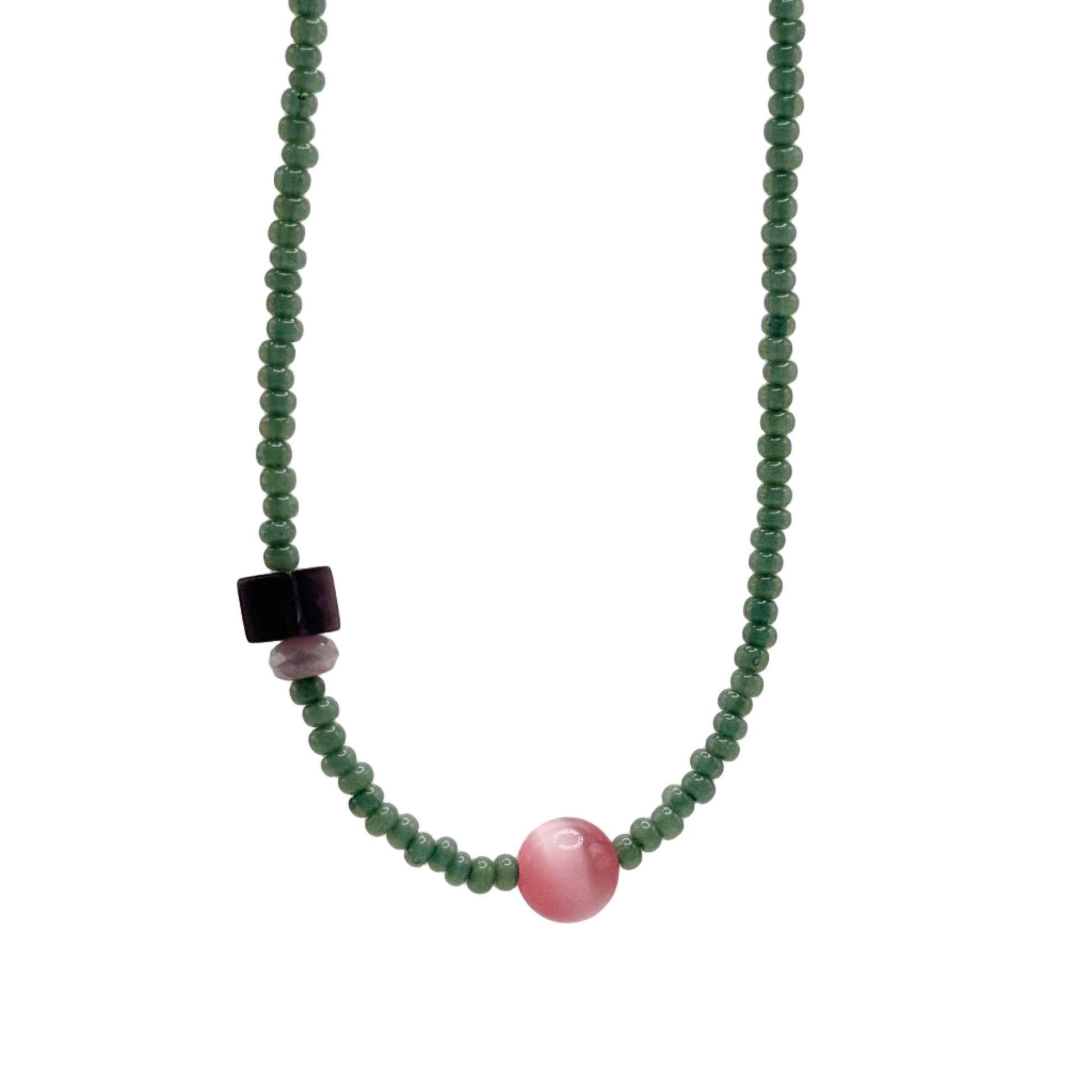 Necklace with green beads and a pink and black bead on a light gray background