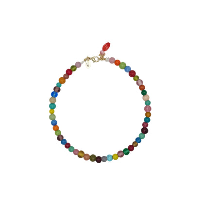 Multicolored beaded necklace on a light gray background
