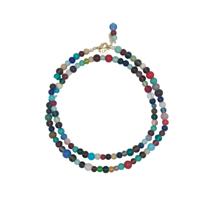 Multicolored beaded necklace on a light gray background