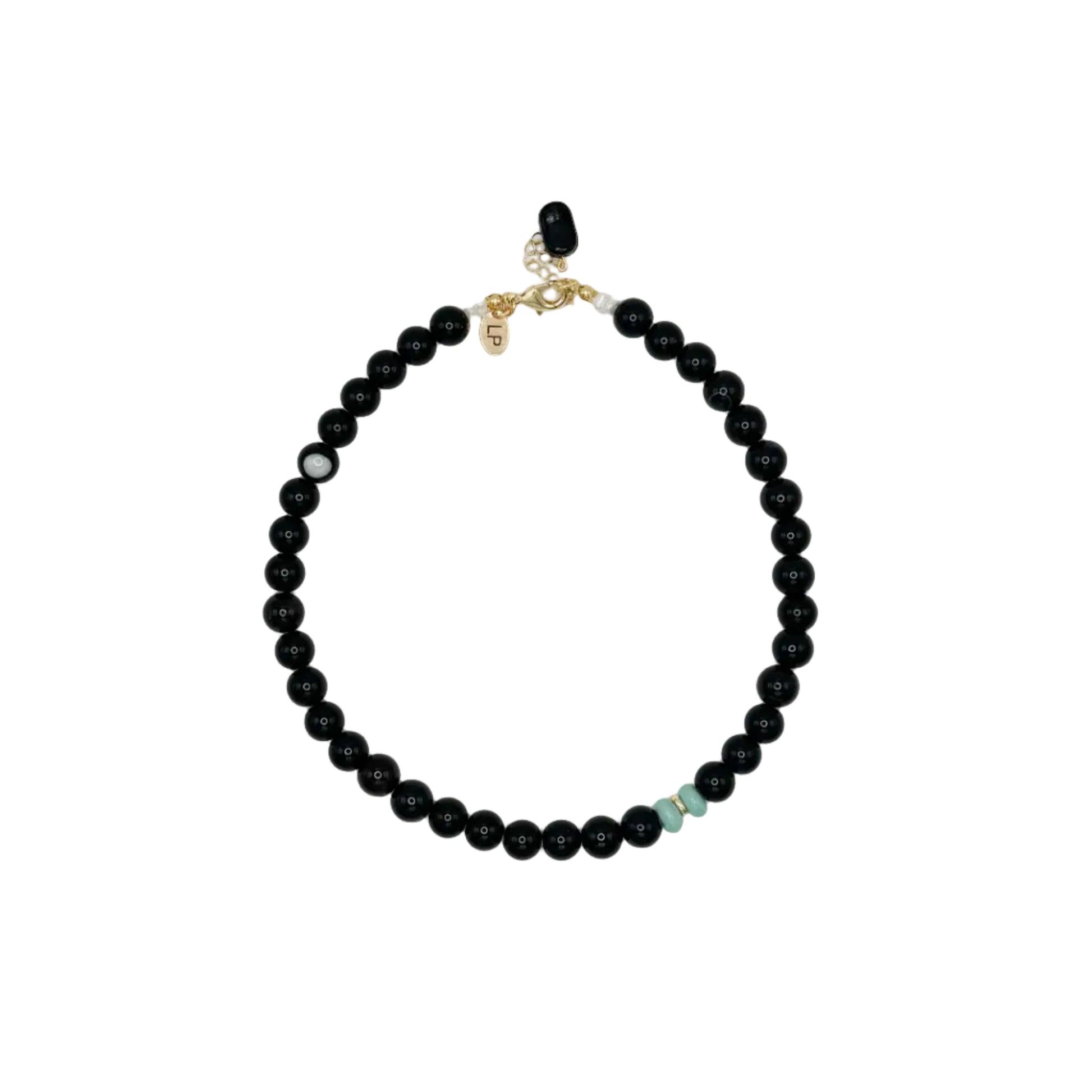 Black beaded necklace on a light gray background