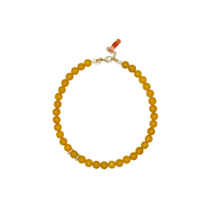 Yellow beaded necklace on a white background