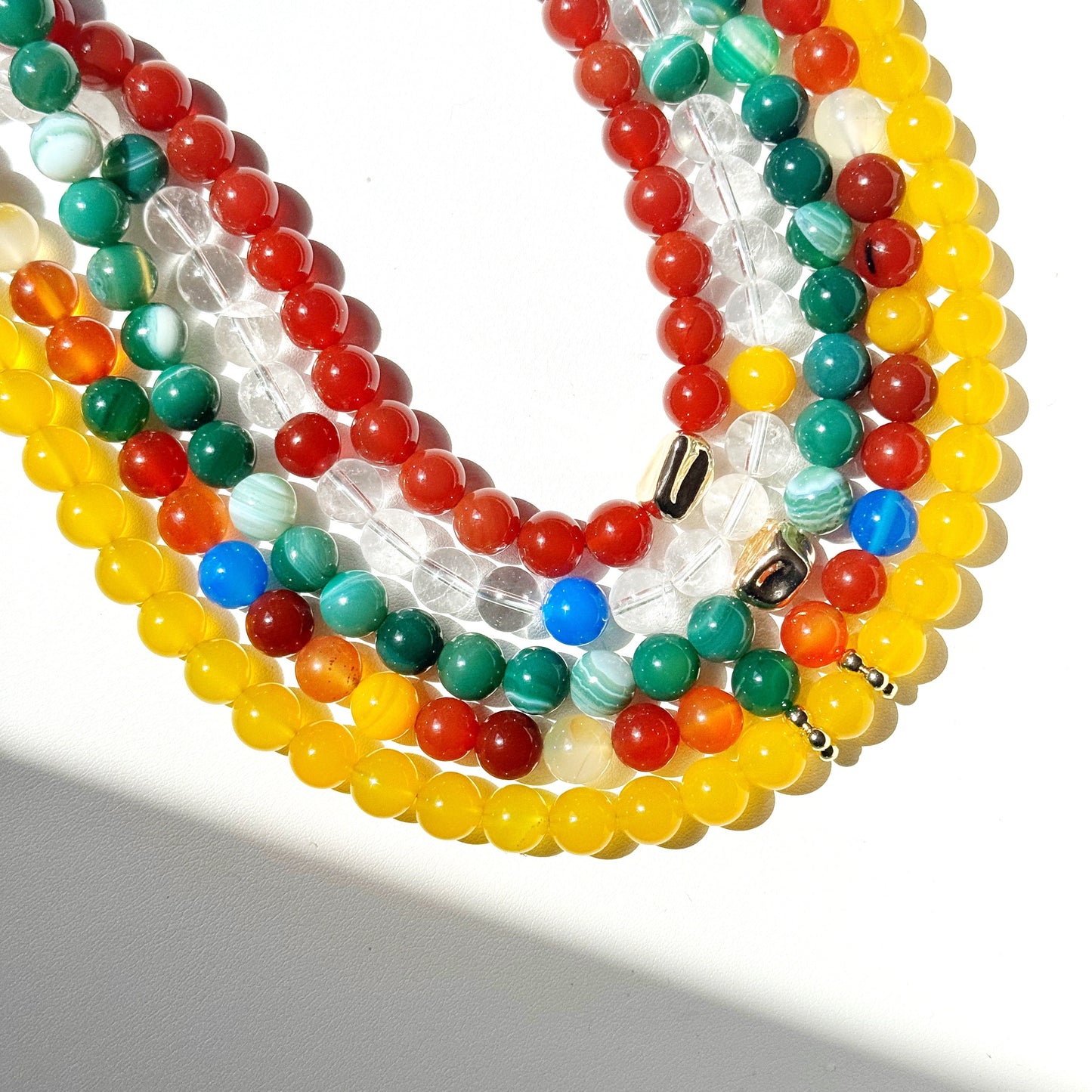Colorful beaded necklaces on a white background