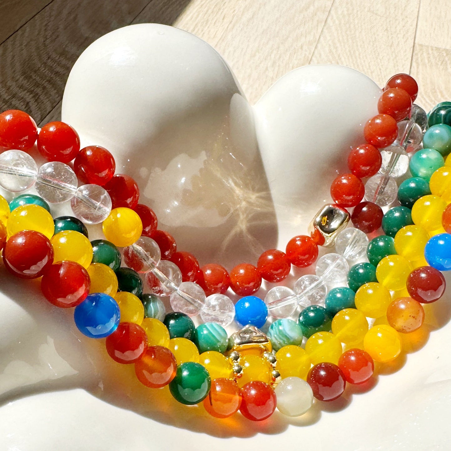 Colorful beaded necklaces on a white sculpture