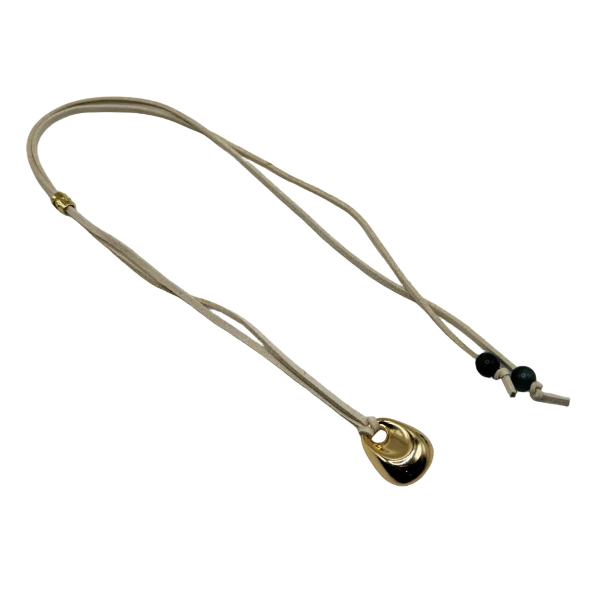 Necklace with a sculptural pendant on a beige cord against a white background