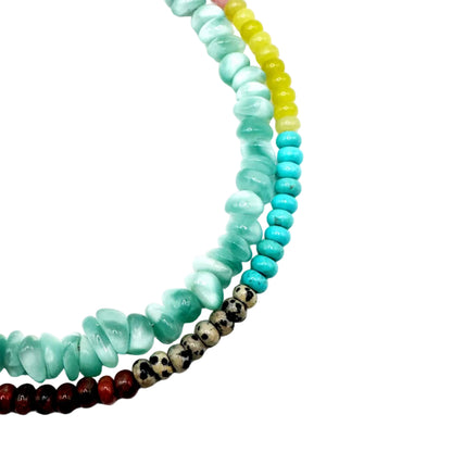 Set of colorful beaded bracelets on a white background