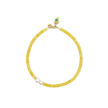 Yellow beaded necklace with a gold clasp on a white background