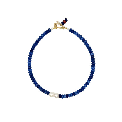 Necklace with blue beads and a gold clasp on a white background
