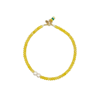 Yellow beaded necklace on a white background