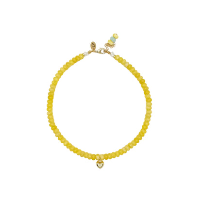 Yellow beaded bracelet on a white background
