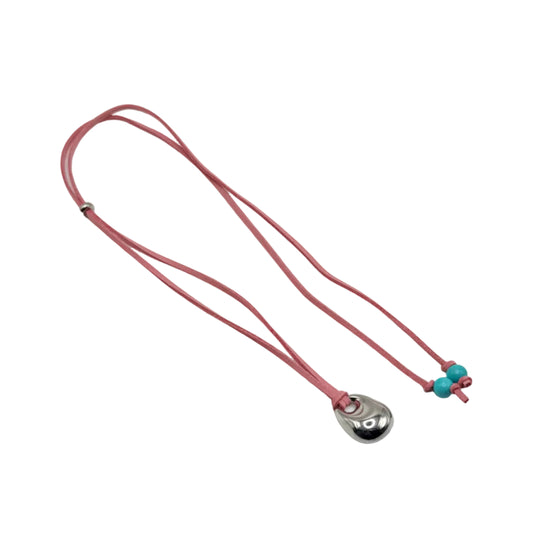 Necklace with a pink cord and silver pendant on a white background