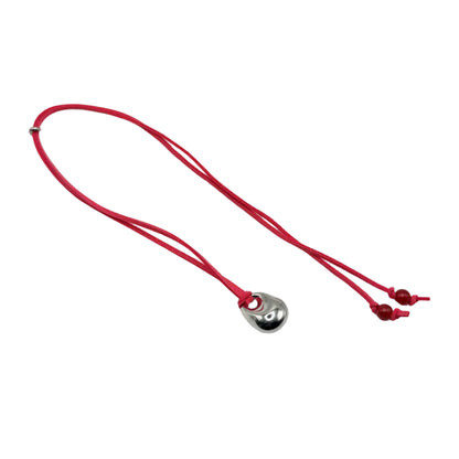 Red necklace with a heart-shaped pendant on a white background