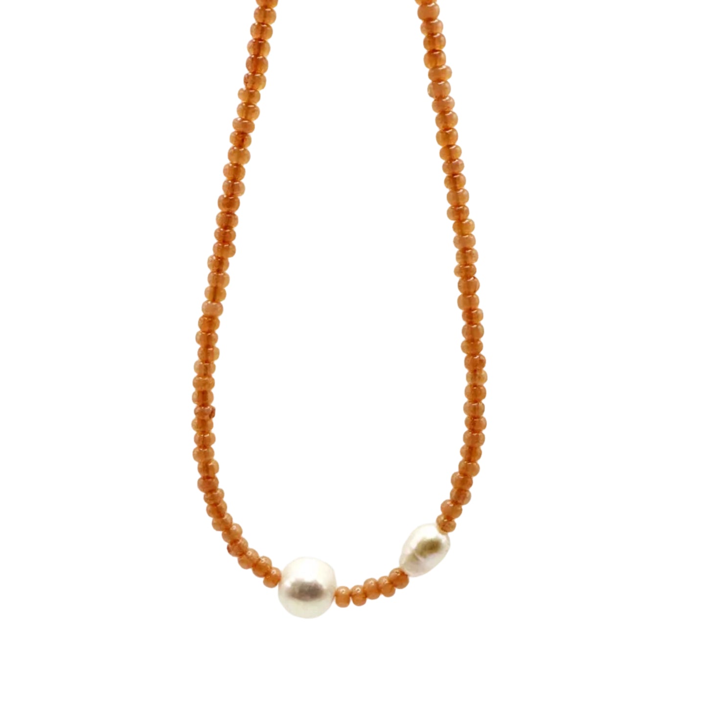 Necklace with orange beads and a small silver pendant on a white background
