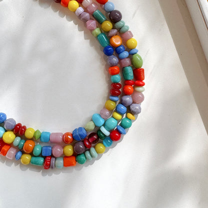 Colorful beaded necklace on a white surface
