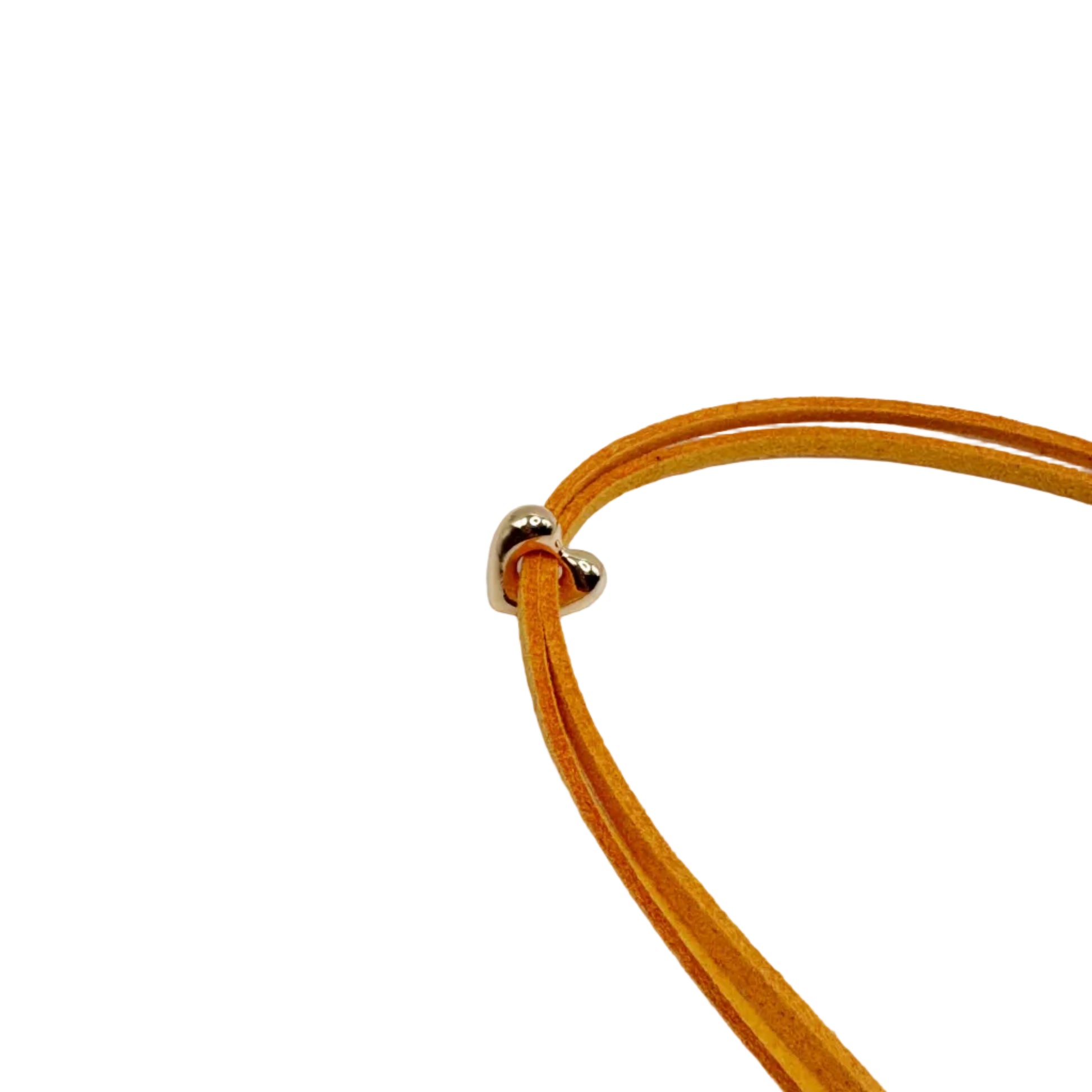 A close-up of a double-strand orange suede cord necklace with a small silver metal bead clasp, set against a plain white background.