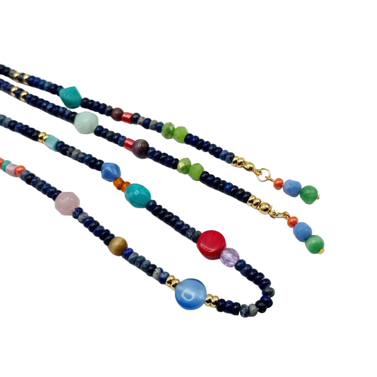 Three beaded necklaces with dark blue seed beads, gold spacer rings, and colorful accent beads in green, blue, red, pink, and purple, arranged on a plain white background.