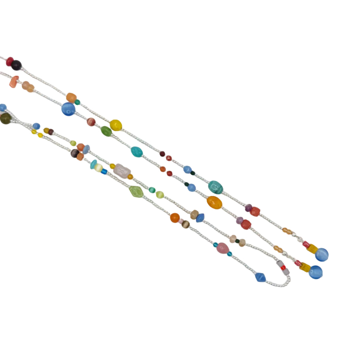 A delicate silver chain necklace featuring a series of colorful, round and oval beads in various shades, laid out diagonally on a plain white background.