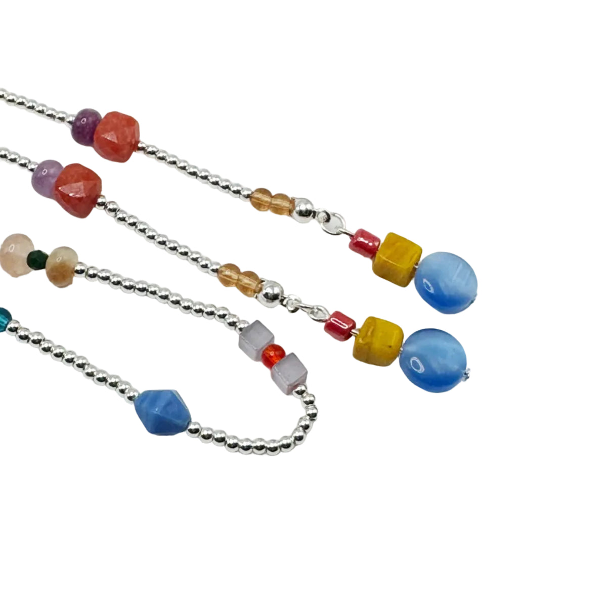 Three silver beaded necklaces with colorful gemstone and wooden beads, displayed diagonally on a plain white background.
