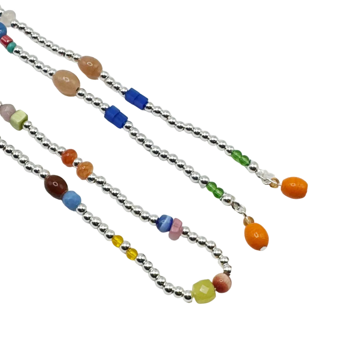 Three beaded necklaces with silver-toned round beads and colorful accent beads, displayed diagonally on a plain white background.
