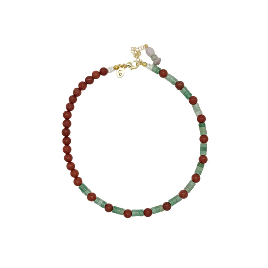 A beaded necklace with alternating dark red and light green round beads, accented by small gold spacer beads and a gold clasp, displayed on a clean white background.