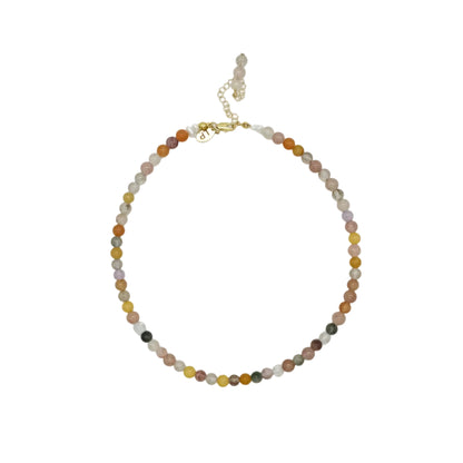 A beaded necklace made of small, polished round beads in earthy tones of brown, orange, yellow, gray, and black, accented by a gold-tone clasp and extender chain, displayed on a clean white background.