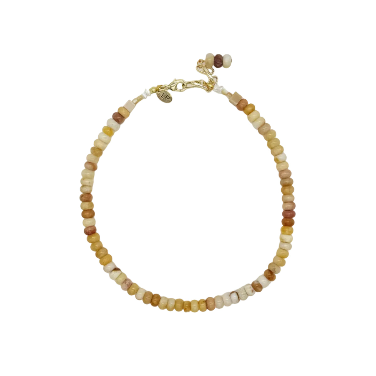 A delicate beaded necklace with small round beads in shades of yellow, brown, and cream, accented by gold-toned metal hardware, displayed on a clean white background.