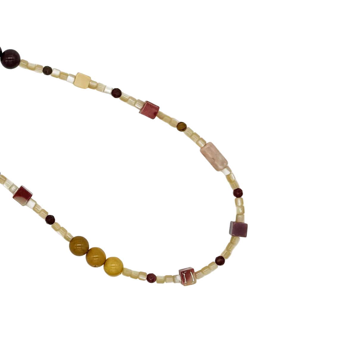 A beaded necklace featuring a mix of cream, brown, yellow, and deep burgundy beads, including cylindrical, square, and round shapes, laid out on a plain white background.