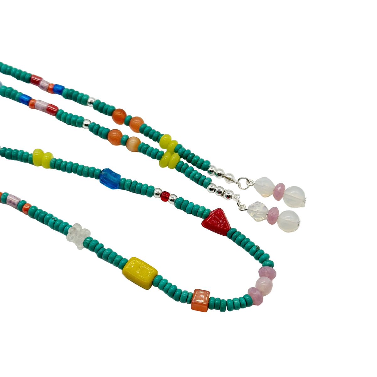 Three beaded necklaces with turquoise-green beads and colorful accents, including yellow, red, blue, orange, pink, and white, displayed on a clean white background.